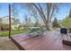 Backyard deck under a large tree with an outdoor dining set, ideal for entertaining and relaxation at 11638 Xavier Way, Westminster, CO 80031