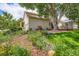 Lush backyard featuring flower beds, mature trees, and a wooden deck perfect for outdoor enjoyment at 11638 Xavier Way, Westminster, CO 80031