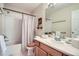 Bathroom with wooden vanity, single sink, shower and tub combination, neutral colors, and mirror at 11638 Xavier Way, Westminster, CO 80031