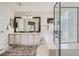 Bright bathroom featuring double vanity, modern fixtures, a soaking tub, and a glass-enclosed shower at 11638 Xavier Way, Westminster, CO 80031