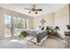 Cozy bedroom bathed in sunlight featuring a ceiling fan and leafy outdoor view at 11638 Xavier Way, Westminster, CO 80031