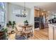 Bright dining area with a round wooden table and natural light from large windows at 11638 Xavier Way, Westminster, CO 80031
