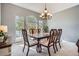 Bright dining room featuring large window, elegant chandelier, and dining set at 11638 Xavier Way, Westminster, CO 80031