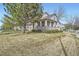 Side view of home with charming porch, stone accents, and well-kept lawn at 11638 Xavier Way, Westminster, CO 80031