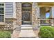 Inviting front door with stone surround and seasonal wreath, creating a warm welcome at 11638 Xavier Way, Westminster, CO 80031