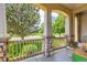 Cozy front porch featuring decorative stone pillars with seating area overlooking landscaped lawn at 11638 Xavier Way, Westminster, CO 80031