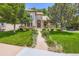 Charming home featuring a stone facade, a well-manicured lawn and mature trees at 11638 Xavier Way, Westminster, CO 80031
