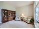 Cozy living room with custom built-in bookcase, plush carpet, and inviting armchairs at 11638 Xavier Way, Westminster, CO 80031