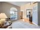 Inviting living room showcasing soaring ceilings, large windows, and wood floors at 11638 Xavier Way, Westminster, CO 80031
