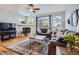 Cozy living room with a fireplace, plush seating, and large windows providing ample light at 11638 Xavier Way, Westminster, CO 80031