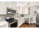 Modern kitchen with white cabinets, stainless steel appliances, and hardwood floors at 3515 Meade St, Denver, CO 80211