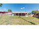 House backyard view, covered patio, and a grassy area at 7609 Sherman Pl, Denver, CO 80221