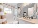 Updated bathroom with white vanity, bathtub, and stylish fixtures at 7609 Sherman Pl, Denver, CO 80221