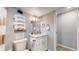Clean and updated basement bathroom with white vanity and gray tile at 7609 Sherman Pl, Denver, CO 80221
