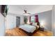 Bright bedroom with hardwood floors, a ceiling fan, and large closet at 7609 Sherman Pl, Denver, CO 80221