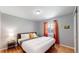Guest bedroom with hardwood floors and a ceiling fan at 7609 Sherman Pl, Denver, CO 80221