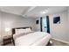Bright basement bedroom with a king-size bed and double doors at 7609 Sherman Pl, Denver, CO 80221