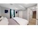 Basement bedroom with king bed and access to hallway and stairs at 7609 Sherman Pl, Denver, CO 80221