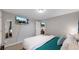 Comfortable basement bedroom with a large TV and lots of natural light at 7609 Sherman Pl, Denver, CO 80221