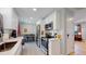 Updated kitchen featuring white shaker cabinets, stainless steel appliances, and a breakfast bar at 7609 Sherman Pl, Denver, CO 80221