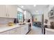 Modern kitchen with white cabinets, stainless steel appliances, and quartz countertops at 7609 Sherman Pl, Denver, CO 80221