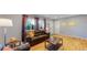 Living room with hardwood floors, leather furniture, and a view of the front yard at 7609 Sherman Pl, Denver, CO 80221