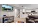 Open living area with a kitchen, TV, and comfortable seating at 7609 Sherman Pl, Denver, CO 80221