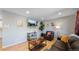 Living room featuring hardwood floors, comfy leather couches, and a large TV at 7609 Sherman Pl, Denver, CO 80221