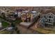 Aerial view of a two-story home with solar panels, a backyard fire pit, and a patio at 26656 E Peakview Dr, Aurora, CO 80016