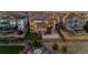 Aerial view of a home with solar panels, outdoor patio, fire pit, and well-manicured lawn at 26656 E Peakview Dr, Aurora, CO 80016