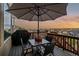 Back deck with table, chairs and grill with sunset views in the background at 26656 E Peakview Dr, Aurora, CO 80016
