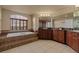 Bright bathroom featuring a soaking tub with tile surround and double sink vanity at 26656 E Peakview Dr, Aurora, CO 80016