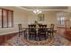 Formal dining room featuring a patterned rug, a chandelier, and wainscotting detail at 26656 E Peakview Dr, Aurora, CO 80016