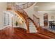 Stunning foyer with wood floors, a curved staircase, and an abundance of natural light at 26656 E Peakview Dr, Aurora, CO 80016