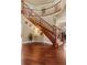 Elegant foyer with dark wood floors and a staircase featuring carpeted steps and wooden railings at 26656 E Peakview Dr, Aurora, CO 80016