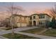 Two story stucco home featuring a spacious three car garage and well manicured front lawn at 26656 E Peakview Dr, Aurora, CO 80016