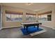 Game room with a pool table, and three bright windows with beautiful sunset view at 26656 E Peakview Dr, Aurora, CO 80016