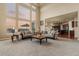 Bright, open living room with soaring windows offering stunning views, paired with comfortable seating and plush carpeting at 26656 E Peakview Dr, Aurora, CO 80016