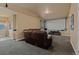 Spacious living room with theater screen, fireplace and comfortable seating with neutral carpet at 26656 E Peakview Dr, Aurora, CO 80016