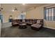 Comfortable living room with a large sectional sofa, coffee table, and a built in bar at 26656 E Peakview Dr, Aurora, CO 80016