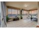 Bright sunroom featuring tile floors, large windows with scenic views, and ample space for relaxation and potted plants at 26656 E Peakview Dr, Aurora, CO 80016