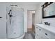 Updated bathroom featuring a glass shower, modern vanity, and wood-look flooring at 27857 Apex Cir, Evergreen, CO 80439
