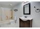 Bathroom with a shower-tub combo, updated vanity, and tile flooring at 27857 Apex Cir, Evergreen, CO 80439