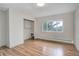 Bedroom with hardwood floors, a large window with natural light, and a closet at 27857 Apex Cir, Evergreen, CO 80439