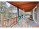Expansive wood deck with railings and a view of the surrounding trees at 27857 Apex Cir, Evergreen, CO 80439