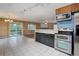 Kitchen and dining area with stainless steel appliances, tile flooring and natural light at 27857 Apex Cir, Evergreen, CO 80439