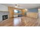 Well-lit living room with wood-look floors, a fireplace, and a ceiling fan at 27857 Apex Cir, Evergreen, CO 80439