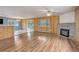 Cozy living room with wood-look flooring, a stone fireplace, and a ceiling fan at 27857 Apex Cir, Evergreen, CO 80439