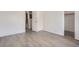 Well-lit bedroom with wood-look floors and mirrored closet doors at 10212 W 80Th Dr # D, Arvada, CO 80005