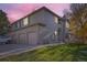 Two-story townhome with attached garage and landscaped lawn at 10212 W 80Th Dr # D, Arvada, CO 80005